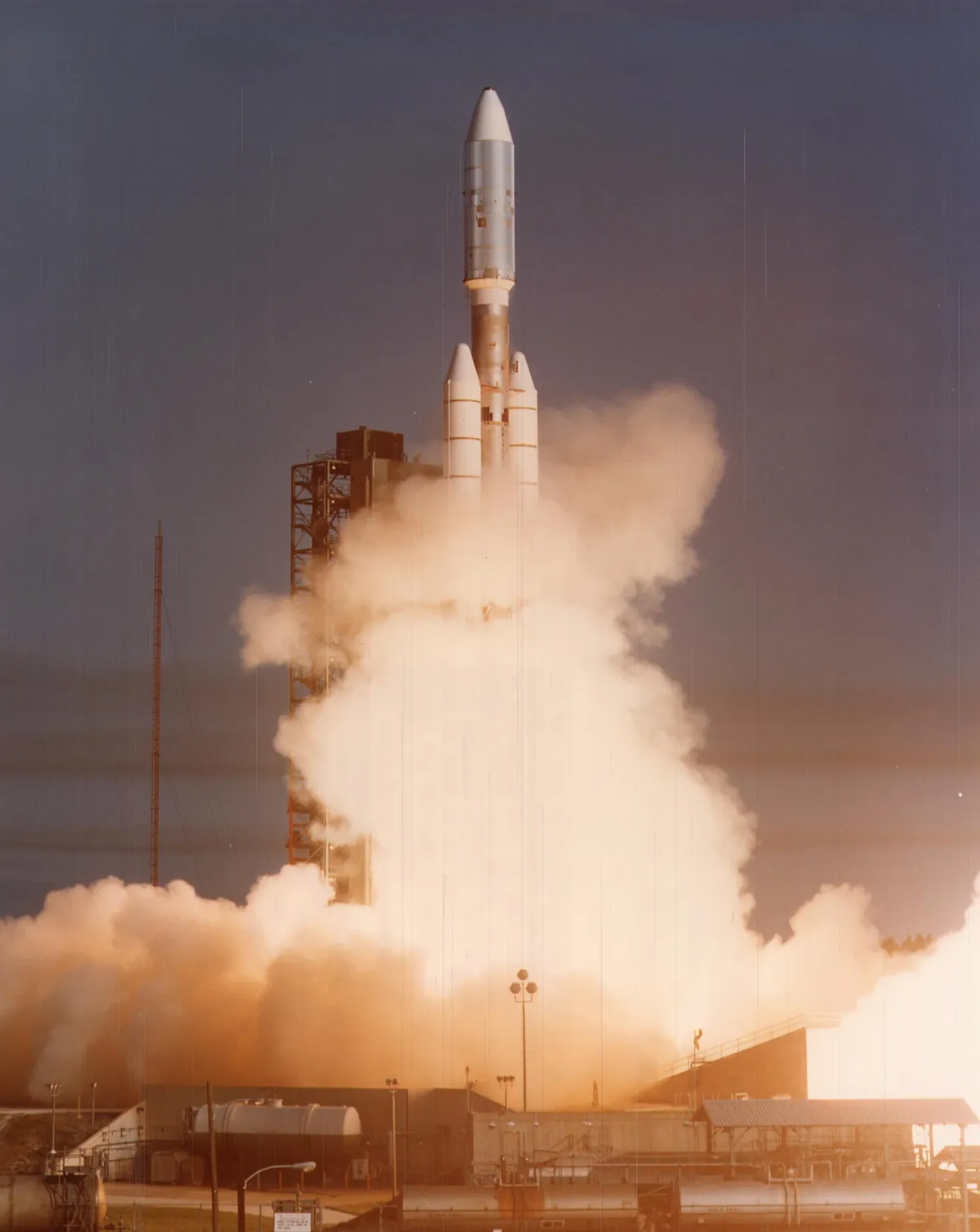 A rocket lifting off from a launch pad on a column of fire and smoke